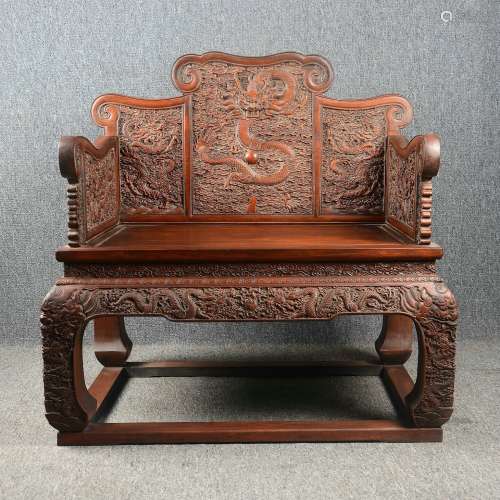 Mahogany throne full of carved dragons