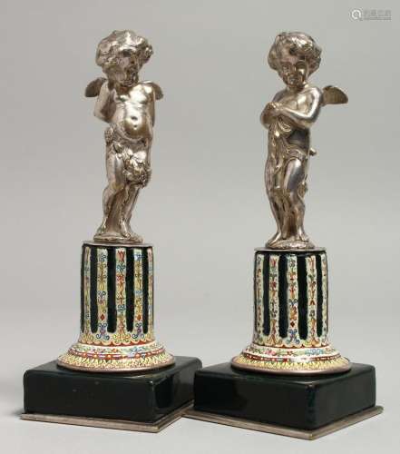 A VERY GOOD PAIR OF SILVERED METAL WINGED CUPIDS standing on...