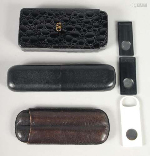 THREE LEATHER CIGAR CASES AND TWO CUTTERS (5).