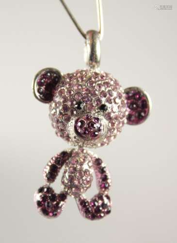 A SILVER TEDDY BEAR PENDANT set with pink stones.
