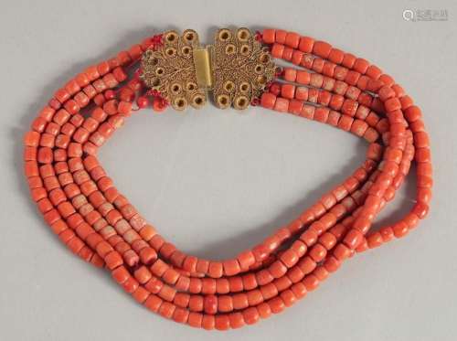 A FIVE ROW CORAL NECKLACE with filigree gold clasp.