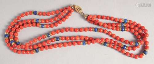 A THREE ROW CORAL NECKLACE with gold clasp.