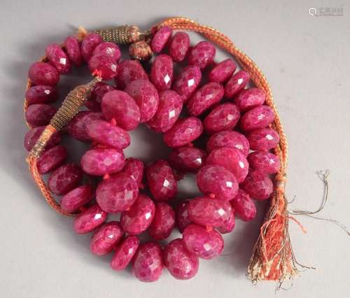 A LARGE CUT GLASS RUBY NECKLACE. 22ins long.