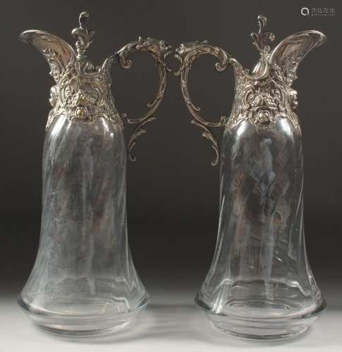 A VERY GOOD PAIR OF GLASS CLARET JUGS with plated mounts and...