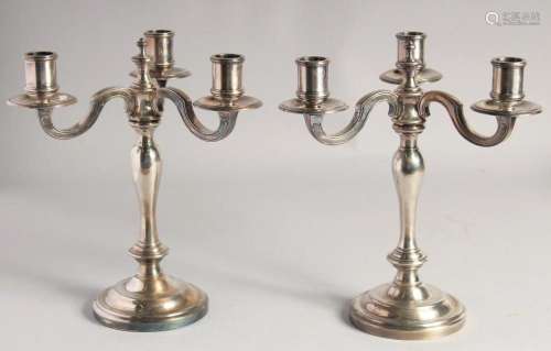 A PAIR OF CHRISTOFLE SILVER PLATED THREE BRANCH CANDELABRAS ...