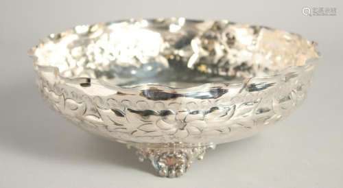 A CONTINENTAL SILVER PLATED CIRCULAR HAMMERED BOWL supported...