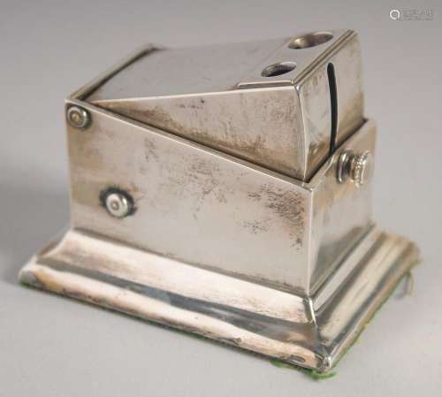 A SILVER TABLE CIGAR CUTTER with crest. 3ins x 2ins. London,...