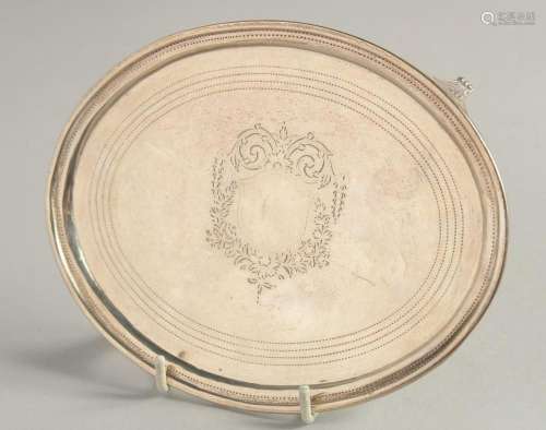 A GEORGE III OVAL SILVER TEA POT STAND with centre cartouche...