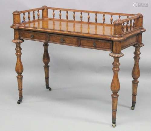 A 19TH CENTURY WALNUT WRITING TABLE with spindle back, slidi...