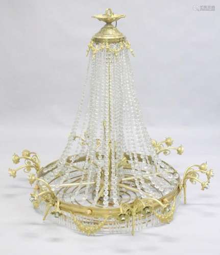 A LARGE ORMOLU AND CRYSTAL CIRCULAR CHANDELIER with four row...