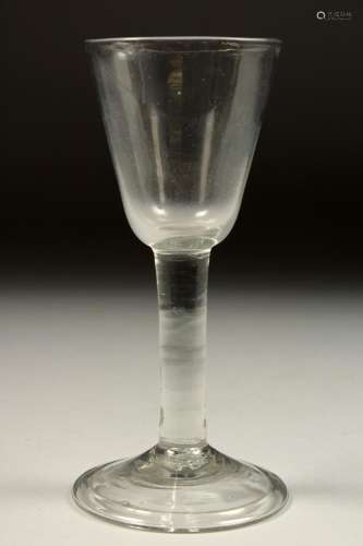 A GEORGIAN WINE GLASS with plain bowl 6.25ins high.