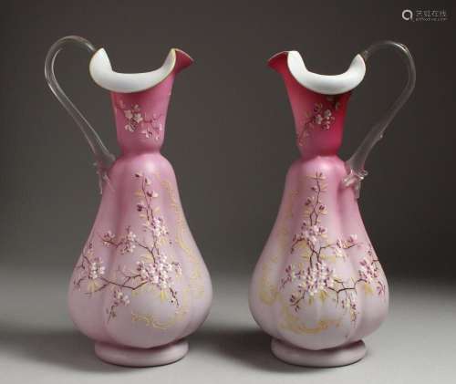 A PAIR OF SATIN GLASS JUGS painted with flowers. 12ins high.