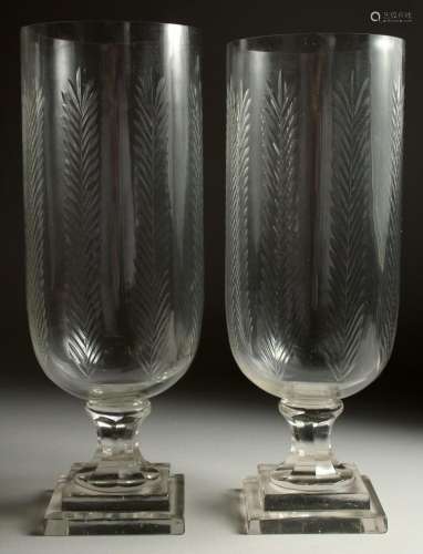 A PAIR OF CUT GLASS STORM LAMPS on square bases. 15ins high.