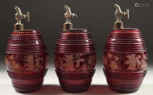 A SET OF THREE BOHEMIAN RUBY GLASS BARRELS engraved with dee...