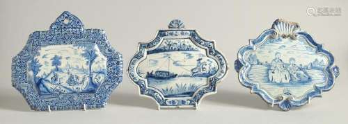 THREE 19TH CENTURY DUTCH BLUE AND WHITE SHAPED PLAQUES, a ho...