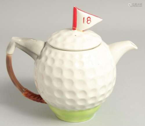 A TONY WOOD GOLF BALL TEA POT AND COVER. 8ins high.