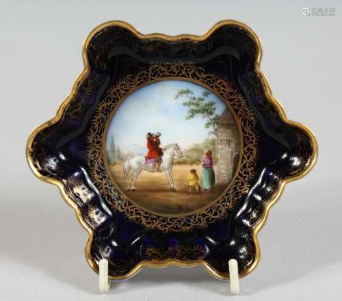 A SMALL VIENNA BLUE GROUND SHAPED DISH, a man on horseback B...