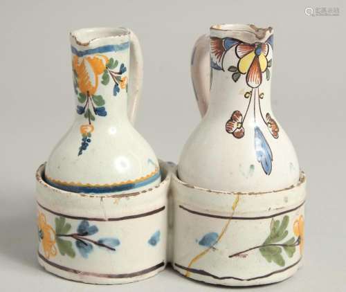 AN 18TH CENTURY TIN GLAZE CRUET with two jugs and a carrying...