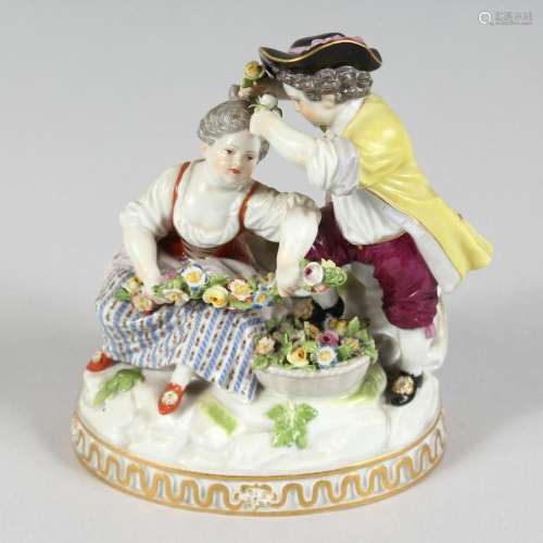 A GOOD MEISSEN PORCELAIN GROUP OF A BOY AND GIRL with garlan...