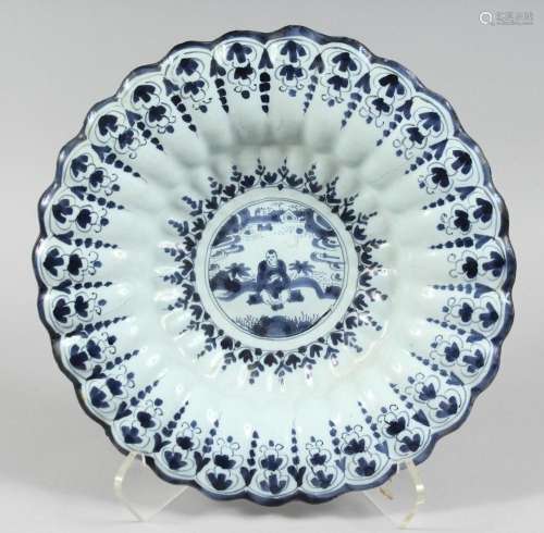 A 19TH CENTURY BLUE AND WHITE RIBBED CHARGER with Chinese de...