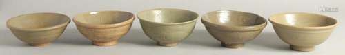 FIVE VARIOUS CELADON GLAZED BOWLS. 5.5ins diameter.