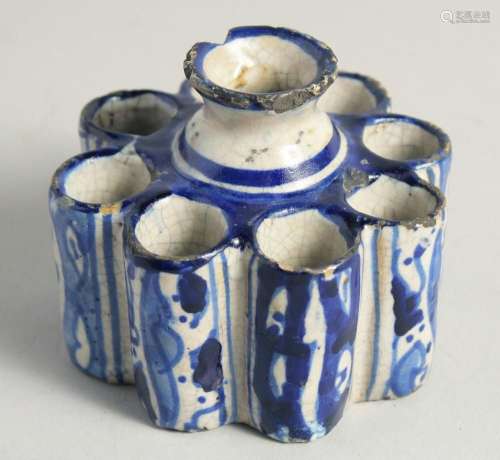 AN EARLY ISLAMIC POTTERY EIGHT DIVISION INKWELL. 3.5ins diam...