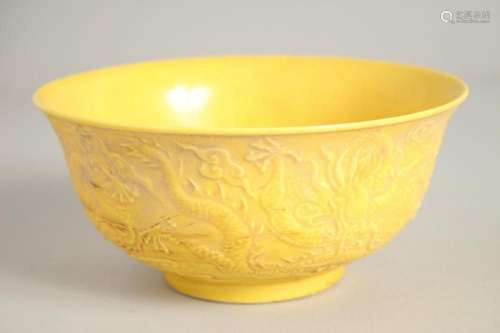 A CHINESE FAMILLE JAUNE CIRCULAR RICE BOWL, dragons in relie...