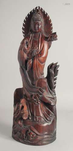 A CHINESE CARVED ROSEWOOD FIGURE. 1ft 11ins long.