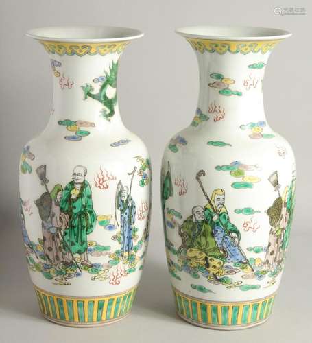 A PAIR OF CHINESE PORCELAIN VASES painted with people. 1ft 5...