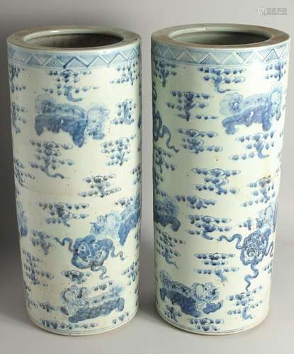 A GOOD PAIR OF CHINESE BLUE AND WHITE UMBRELLA STANDS.