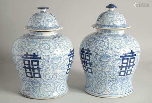 A PAIR OF CHINESE BLUE AND WHITE GINGER JARS AND COVERS. 12i...