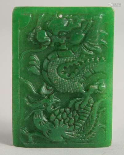 A CHINESE CARVED DRAGON JADE PENDANT. 2ins