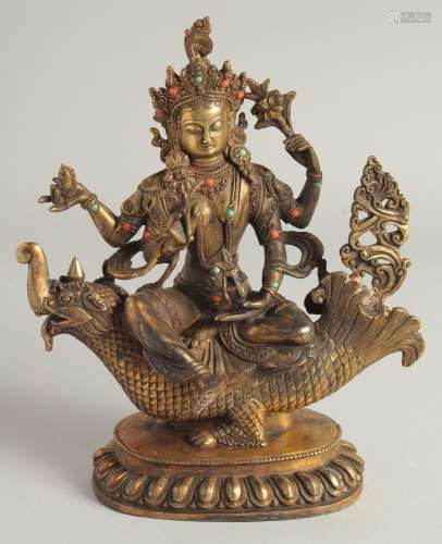 A CHINESE GILT BRONZE GOD seated on a dragon. 10ins high.