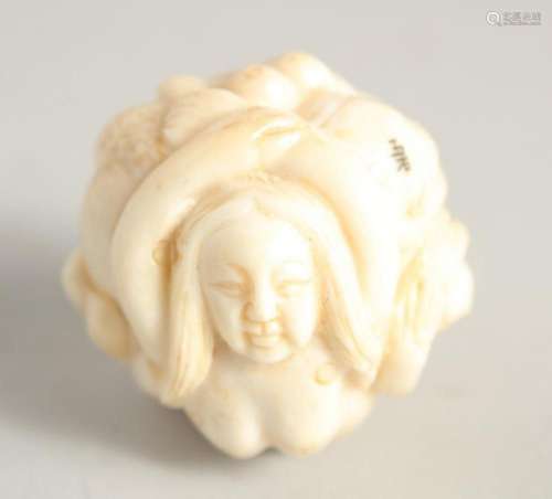 A CHINESE CARVED BALL NETSUKE "NUDE". 1.25ins diam...