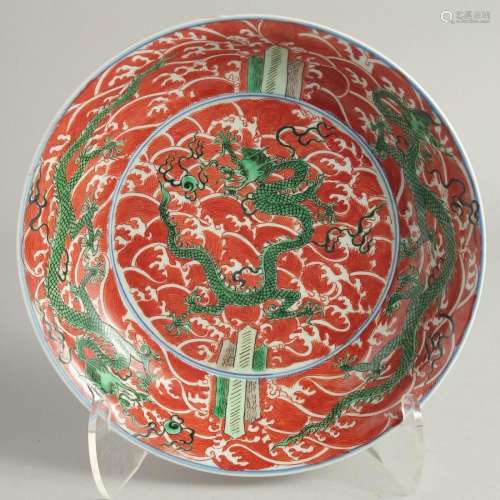 A CHINESE IRON RED GROUND PORCELAIN DISH painted with green ...