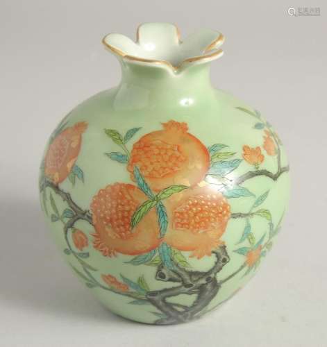 A SMALL GREEN GLAZE BULB VASE decorated with pomegranate blo...