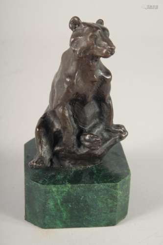 A SMALL BRONZE OF A BEAR. 5ins high on a marble base.