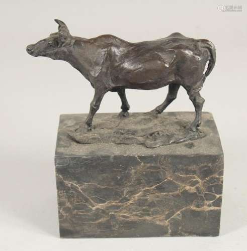 A SMALL BRONZE OF A BULL 5ins long on a marble base.