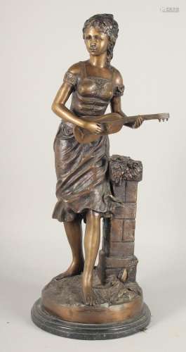 AFTER A MOIREAU. A LARGE BRONZE OF A GIRL playing a mandolin...