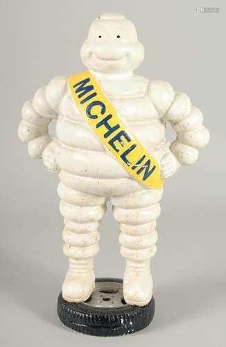 A CAST IRON  MICHELIN MAN . 1ft 3ins high.