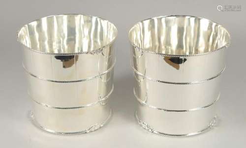 A PAIR OF SILVER PLATED CIRCULAR BARREL COOLERS. 8ins high.