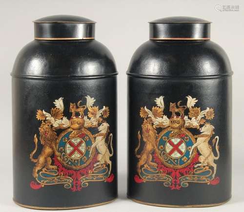 A PAIR OF BLACK TOLEWARE TEA JARS AND COVERS. 11ins high.