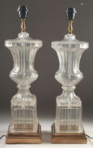 A GOOD PAIR OF GLASS URN SHAPED LAMPS AND BASES 2ft high.