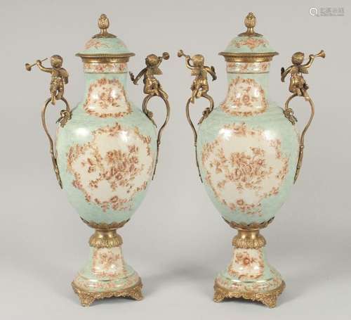 A GOOD PAIR OF FRENCH STYLE PORCELAIN AND METAL URNS AND COV...