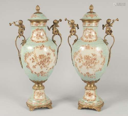 A GOOD PAIR OF FRENCH STYLE PORCELAIN AND METAL URNS AND COV...