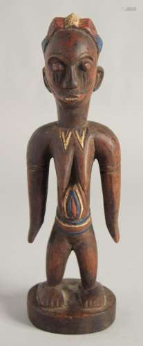 A CARED WOOD TRIBAL FEMALE FIGURE with old pigment. 10.5ins ...
