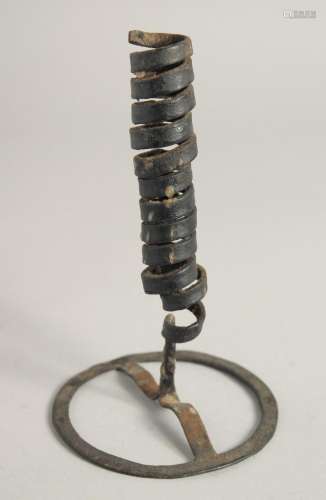 AN EARLY METAL CANDLESTICK. 7ins high.