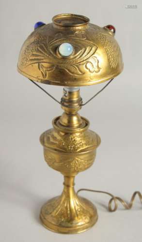 AN ART DECO GILT METAL LAMP set with three coloured stones. ...