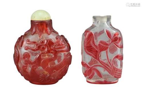 TWO CHINESE GLASS SNUFF BOTTLES. To include a red-overlay gl...