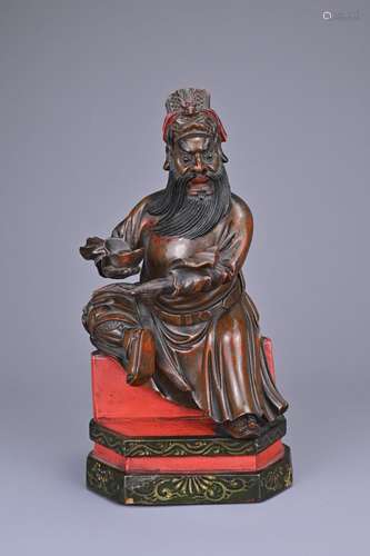 A CHINESE CARVED WOOD LACQUER FIGURE OF CAISHEN, 19TH CENTUR...